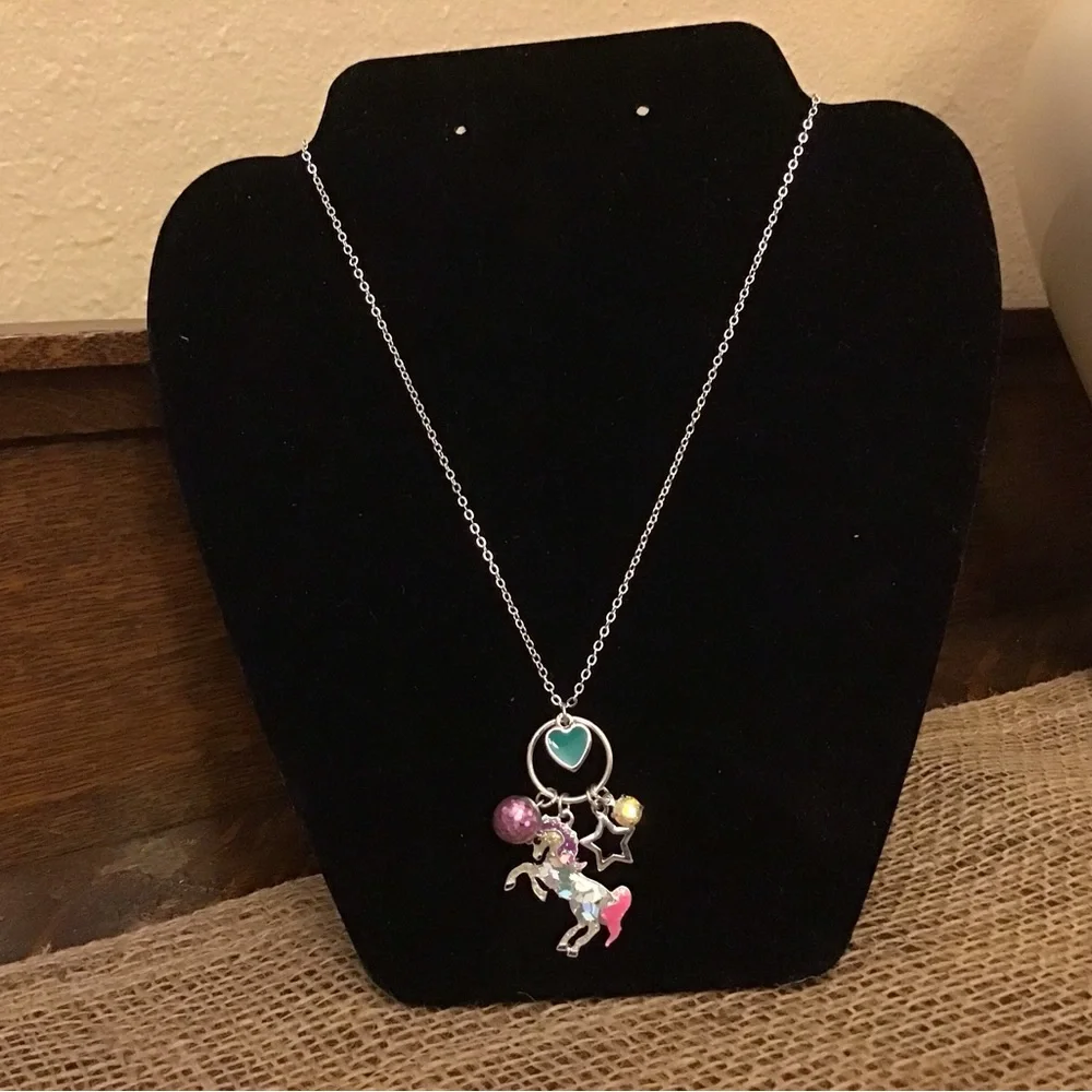 NWT Justice necklace. Unicorn, heart, glitter ball, star and rhinestone charms.